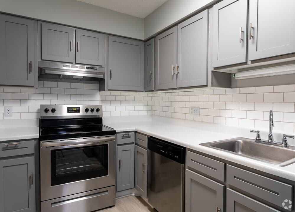 Renovated kitchen with stainless steel appliances and subway tile
